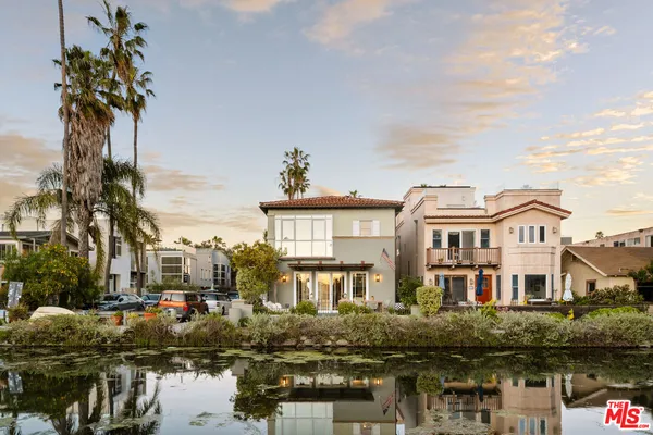 a front view of a house with a lake view
