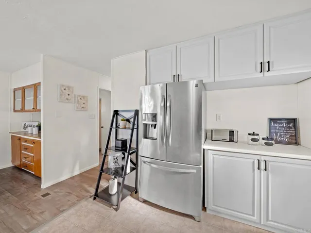 a kitchen with stainless steel appliances a refrigerator sink and cabinets