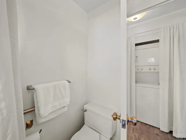 a white toilet sitting next to a bathroom sink