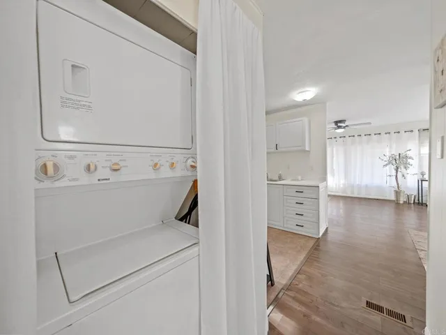 a view of washer and dryer with kitchen in the background