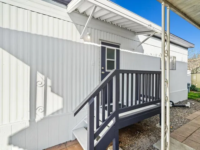 a view of staircase with white walls and a window