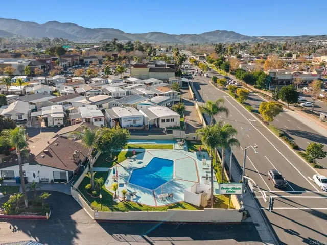an aerial view of residential houses with outdoor space and swimming pool