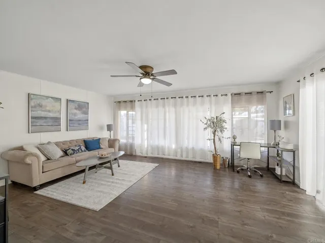 a living room with furniture and wooden floor