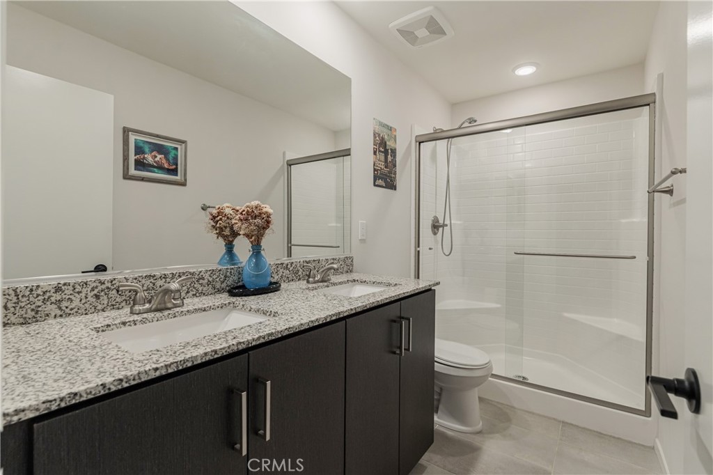 35103 Vintage Cove Fallbrook, CA 92028 - Photo 23 of 66 a bathroom with a granite countertop sink a toilet and shower