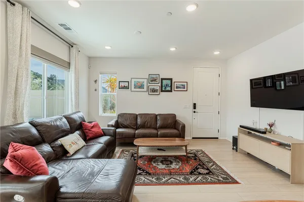 a living room with furniture kitchen and a table