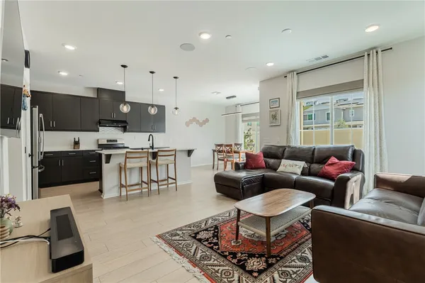 a kitchen with stainless steel appliances kitchen island granite countertop a stove a sink and a refrigerator