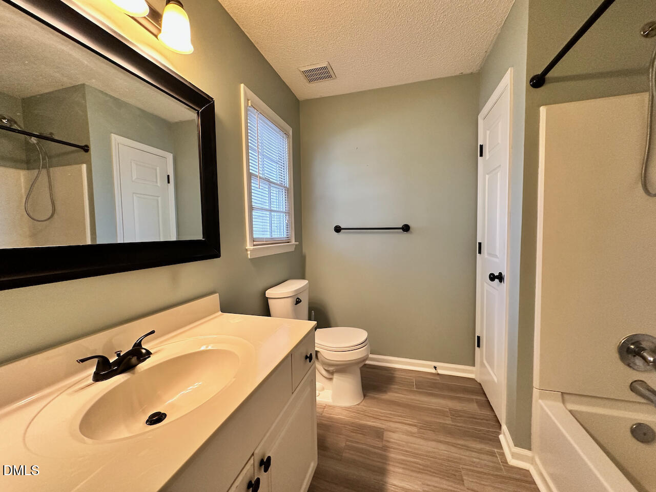 7020 Epping Forest Drive Raleigh, NC 27613 - Photo 13 of 24 a bathroom with a sink and a mirror