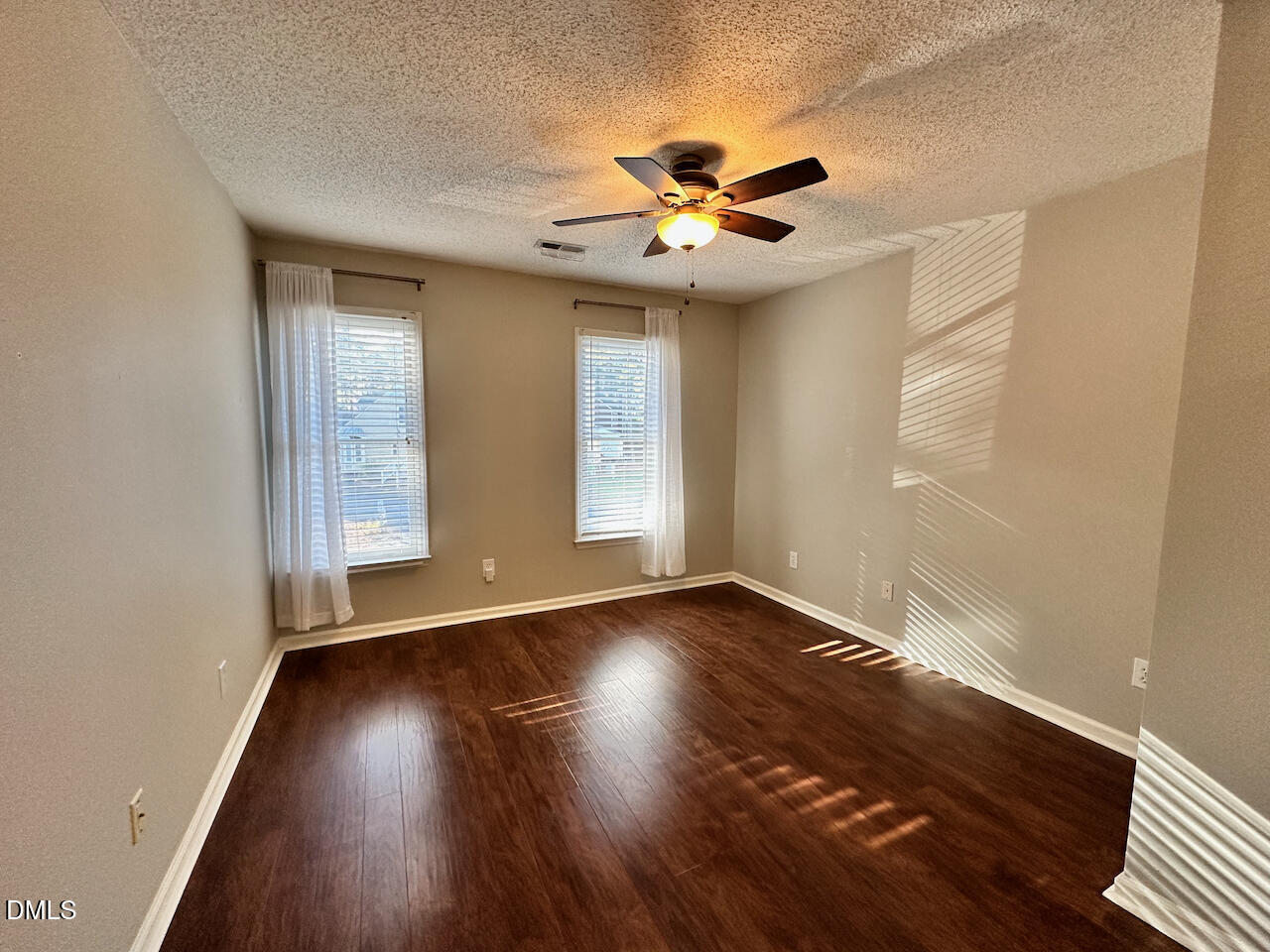 7020 Epping Forest Drive Raleigh, NC 27613 - Photo 15 of 24 a view of an empty room with wooden floor and a window