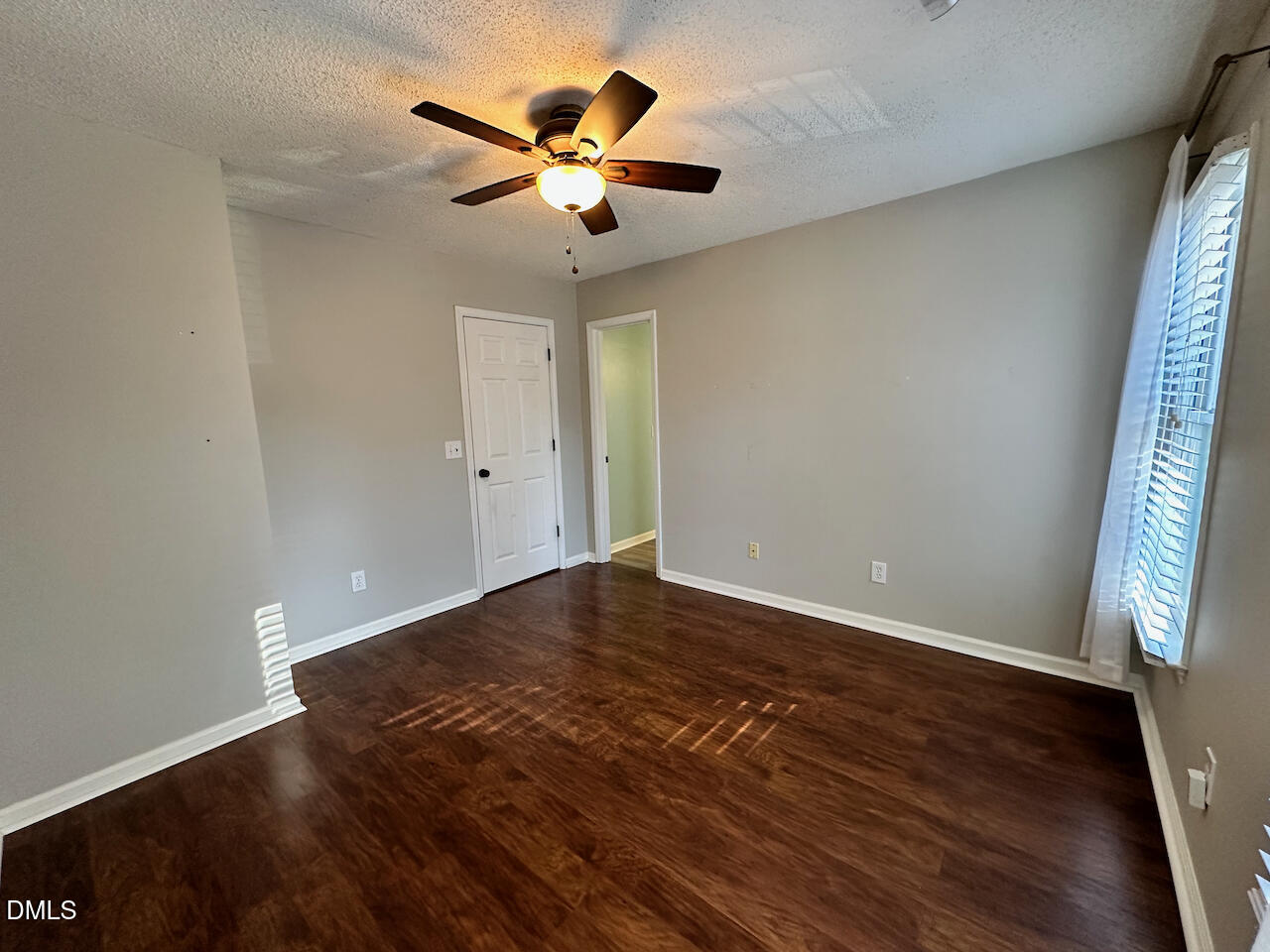 7020 Epping Forest Drive Raleigh, NC 27613 - Photo 16 of 24 an empty room with wooden floor and windows
