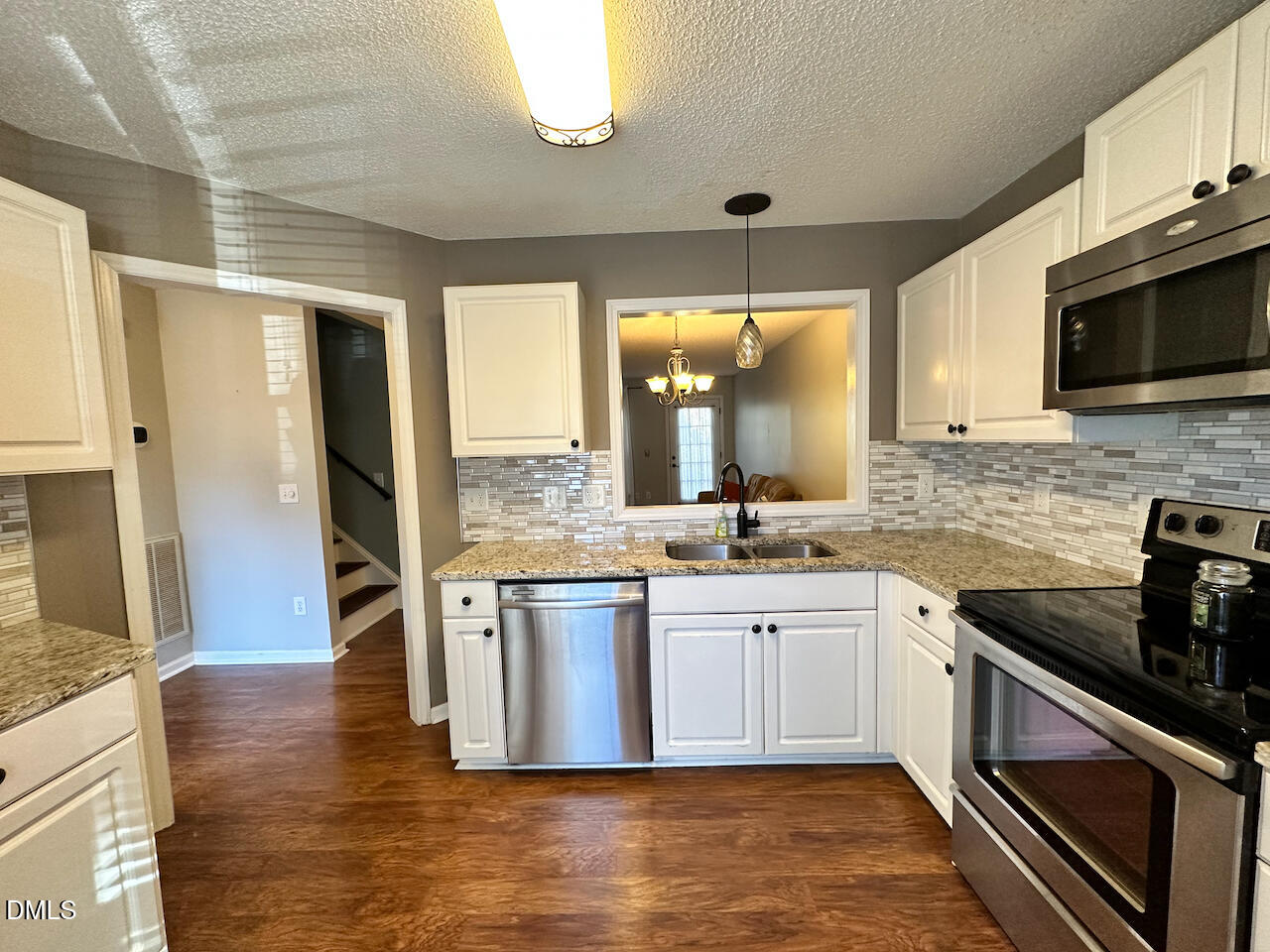 7020 Epping Forest Drive Raleigh, NC 27613 - Photo 5 of 24 a large kitchen with stainless steel appliances granite countertop a stove and a sink