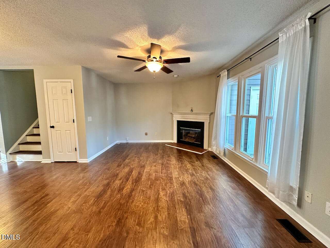 7020 Epping Forest Drive Raleigh, NC 27613 - Photo 9 of 24 wooden floor in an empty room with a fireplace