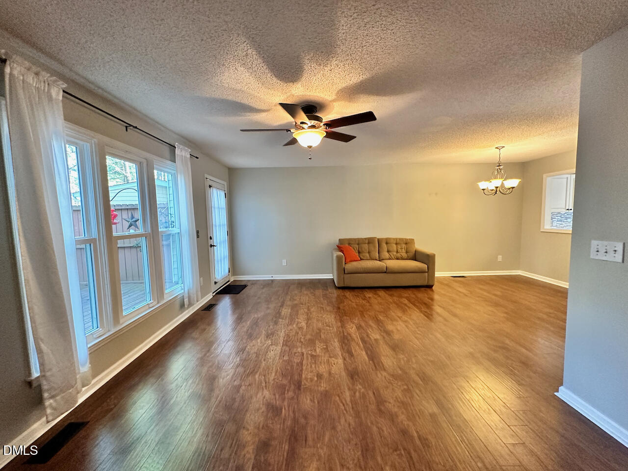 7020 Epping Forest Drive Raleigh, NC 27613 - Photo 10 of 24 a living room with furniture and a chandelier