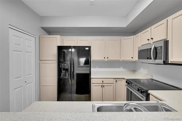 a kitchen with a refrigerator and a sink
