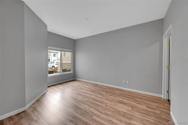 a view of an empty room with wooden floor