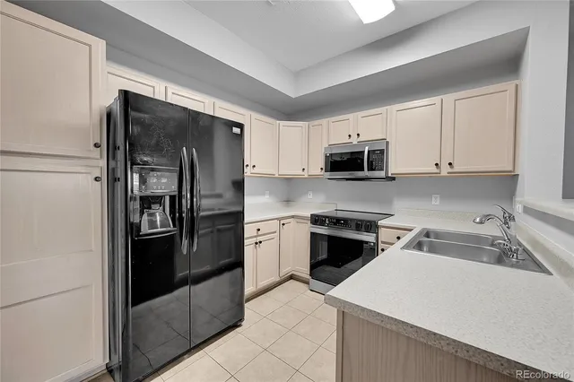 a kitchen with cabinets appliances a sink and a counter top space