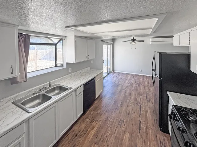 a kitchen with a sink stove and refrigerator