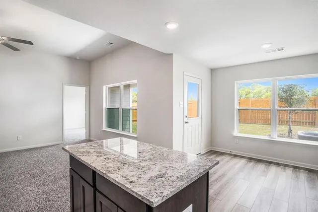 a living room with granite countertop a sink and a window
