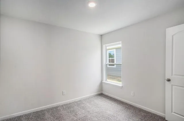 a view of an empty room and window