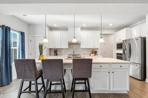 a kitchen with stainless steel appliances granite countertop a sink and stove
