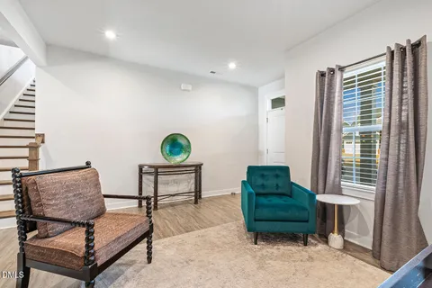 a living room with furniture windows and a flat screen tv