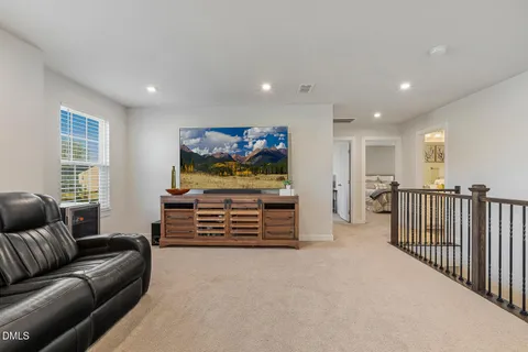 a bedroom with a bed and a chair
