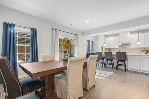 a view of a dining room with furniture and a potted plant