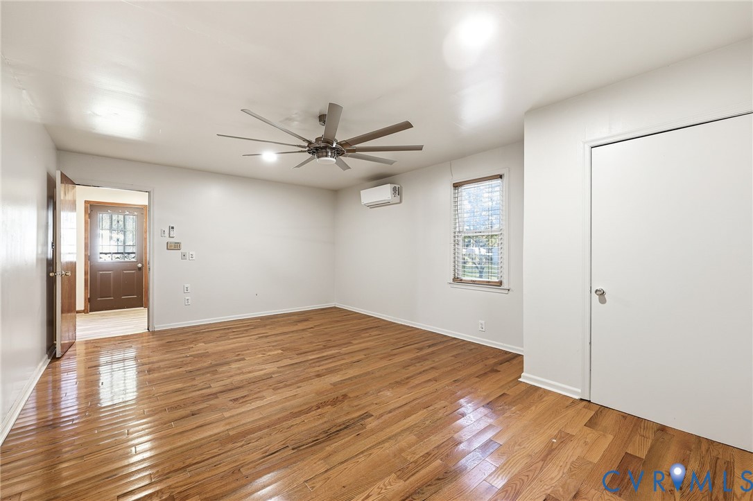 2521 Fort Lee Road Petersburg, VA 23805 - Photo 19 of 27 a view of an empty room with wooden floor and a ceiling fan