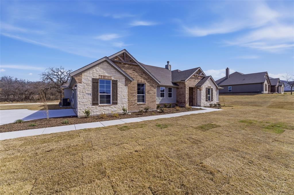 144 Oak Grv Way Springtown, TX 76082 - Photo 3 of 27 a view of a house with a yard