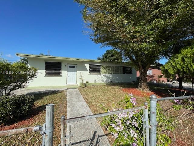 10791 Southwest 221st Street Miami, FL 33170 - Photo 1 of 18 a front view of a house with garden