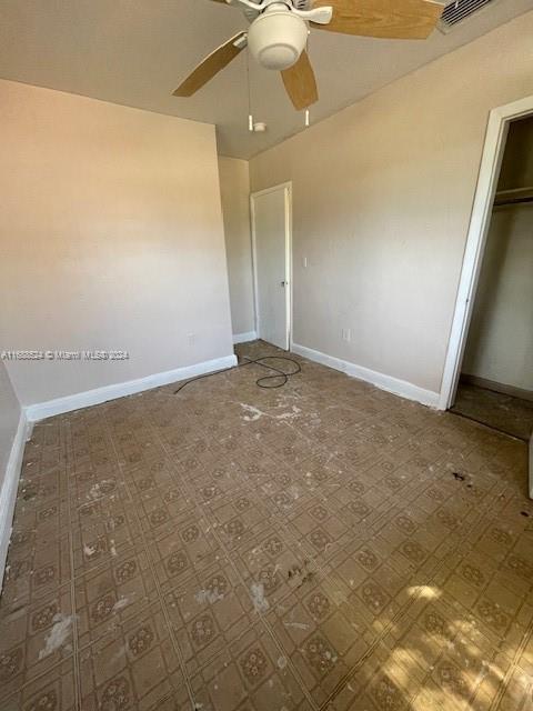 10791 Southwest 221st Street Miami, FL 33170 - Photo 11 of 18 an empty room with a ceiling fan and carpet