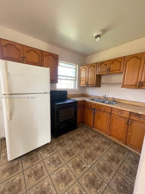 10791 Southwest 221st Street Miami, FL 33170 - Photo 5 of 18 a kitchen with stainless steel appliances granite countertop a refrigerator sink and cabinets