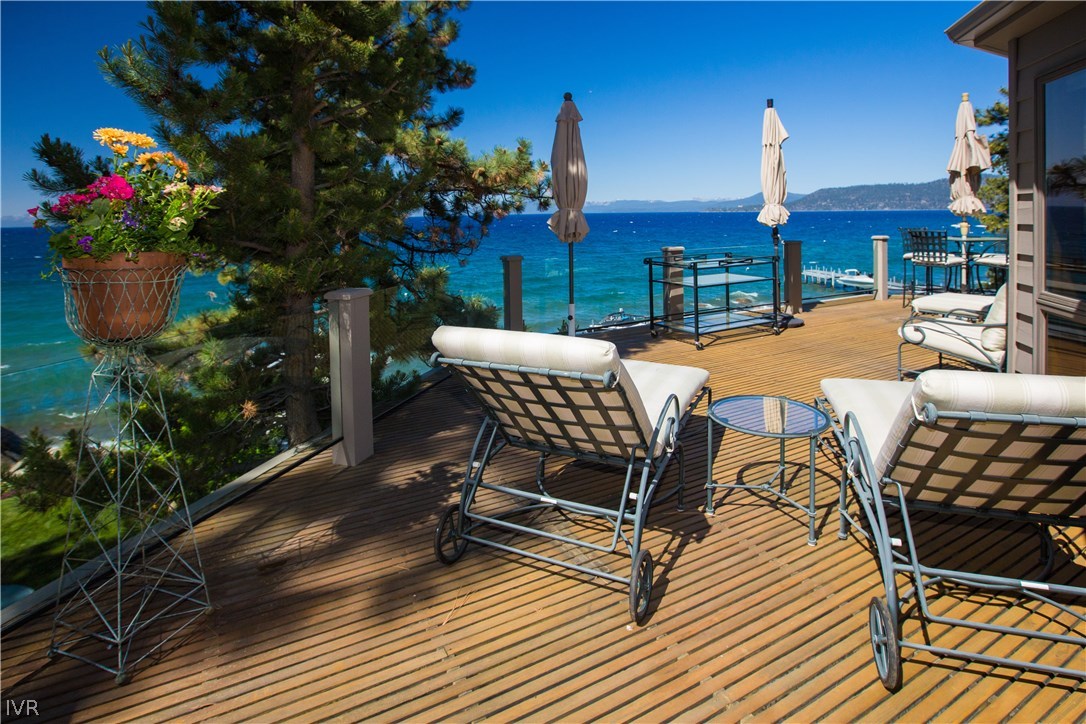 1165 Lakeshore Boulevard Incline Village, NV 89451 - Photo 2 of 25 a roof deck with table and chairs potted plants and a fountain