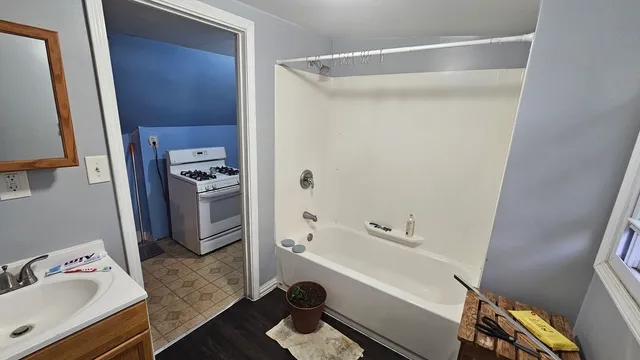 a bathroom with a tub and a sink