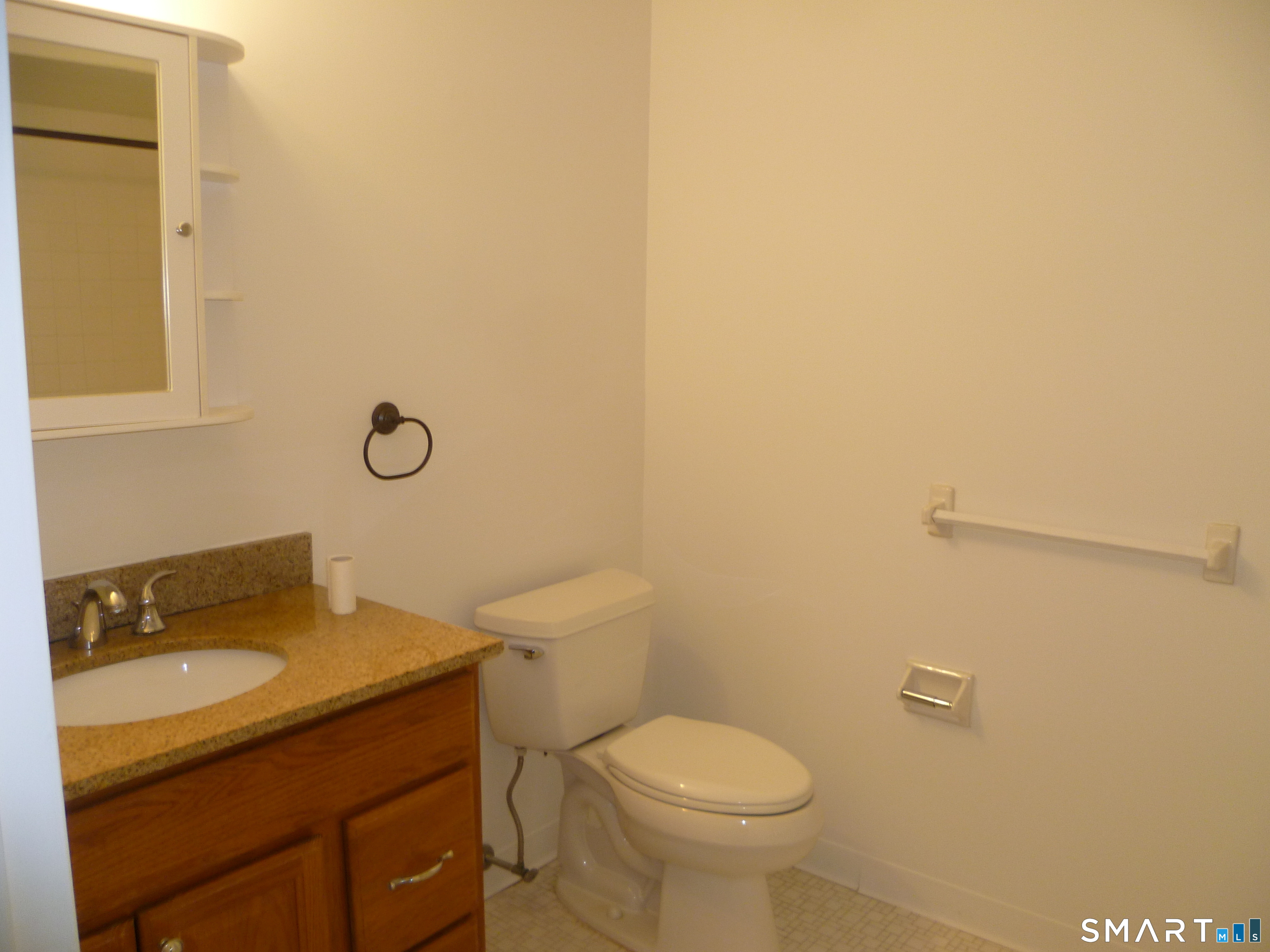 560 Yale Avenue, Unit 4 Meriden, CT 06450 - Photo 8 of 8 a bathroom with a granite countertop toilet and sink