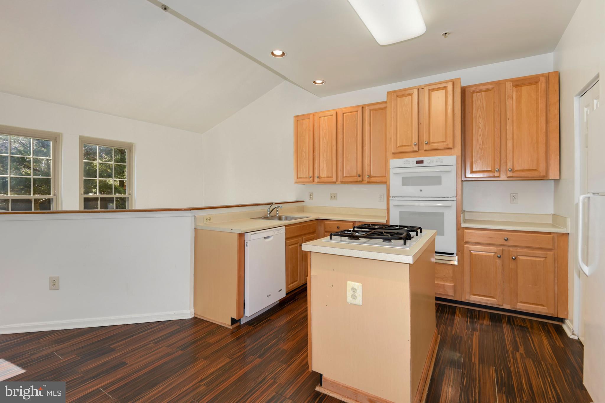 43 Bank Spring Court Owings Mills, MD 21117 - Photo 12 of 27 a kitchen with a stove a sink and a refrigerator