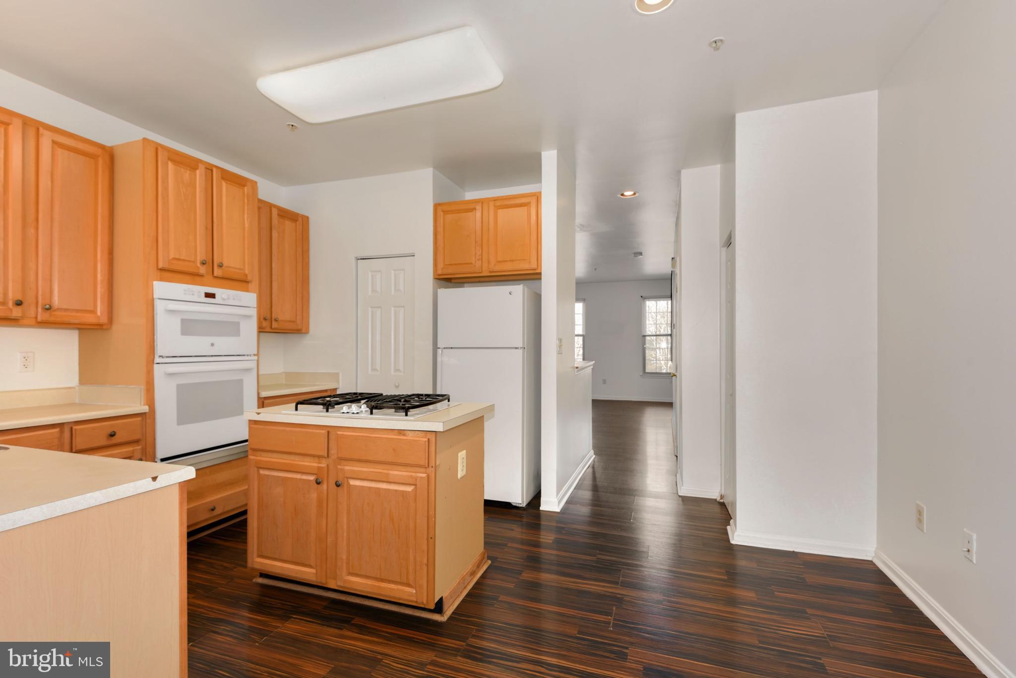 43 Bank Spring Court Owings Mills, MD 21117 - Photo 13 of 27 a kitchen with a stove a refrigerator and wooden floor