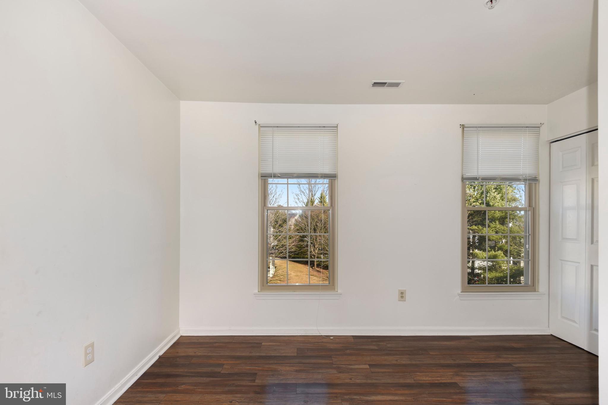 43 Bank Spring Court Owings Mills, MD 21117 - Photo 14 of 27 a view of an empty room with wooden floor and a window
