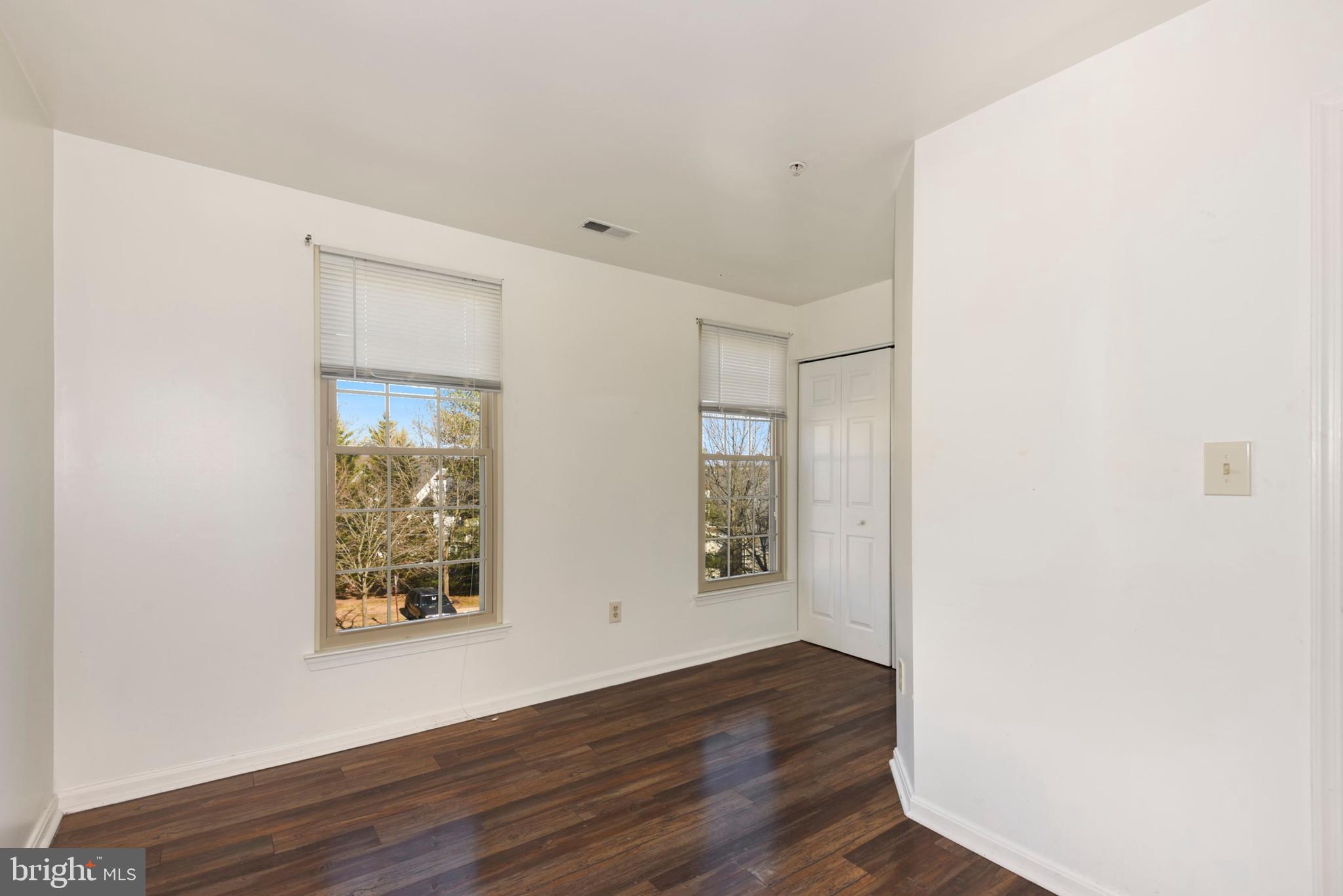43 Bank Spring Court Owings Mills, MD 21117 - Photo 15 of 27 an empty room with wooden floor and windows