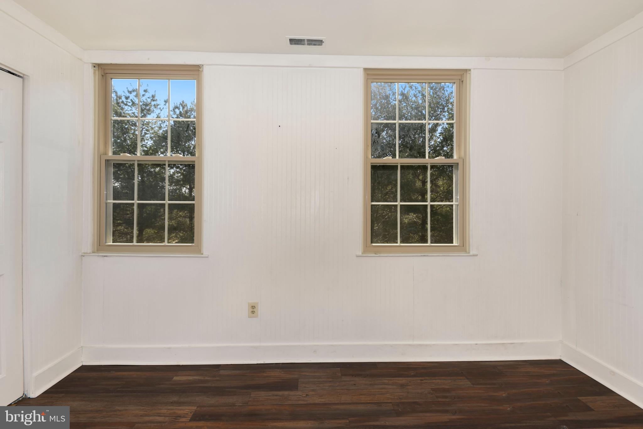 43 Bank Spring Court Owings Mills, MD 21117 - Photo 19 of 27 a view of an empty room with wooden floor and a window