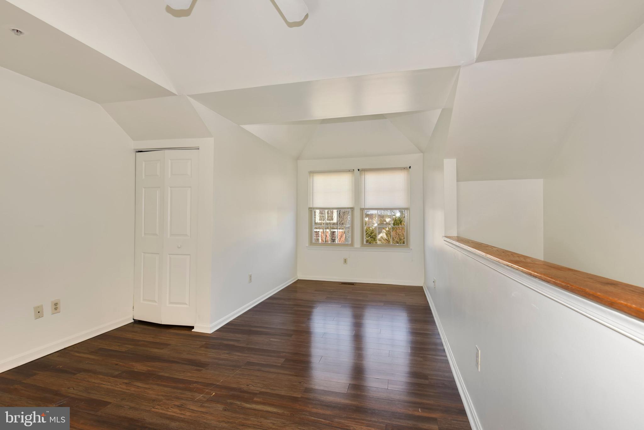 43 Bank Spring Court Owings Mills, MD 21117 - Photo 21 of 27 a view of an empty room with wooden floor and a window