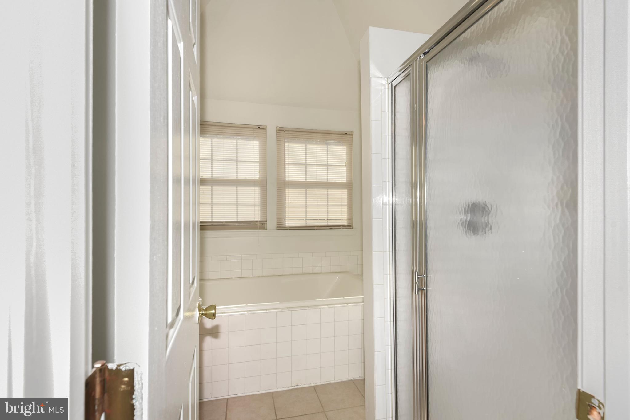 43 Bank Spring Court Owings Mills, MD 21117 - Photo 24 of 27 a bathroom with a glass shower door