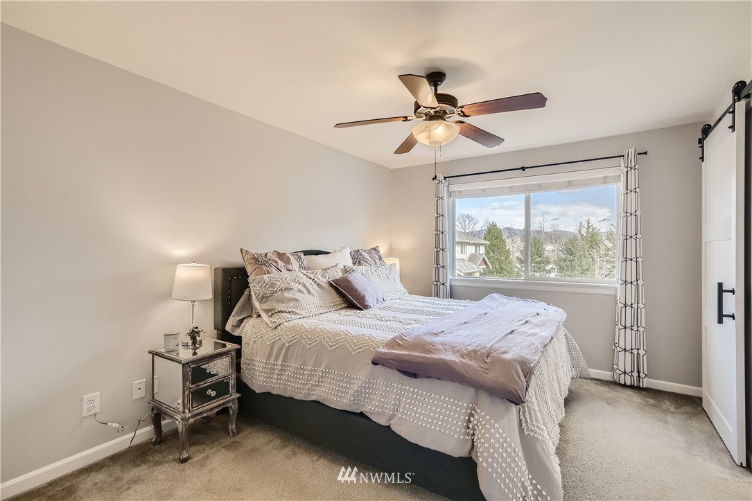 320 Chelan Place Northeast, Unit H3 Renton, WA 98059 - Photo 15 of 28 a bedroom with a bed and a window