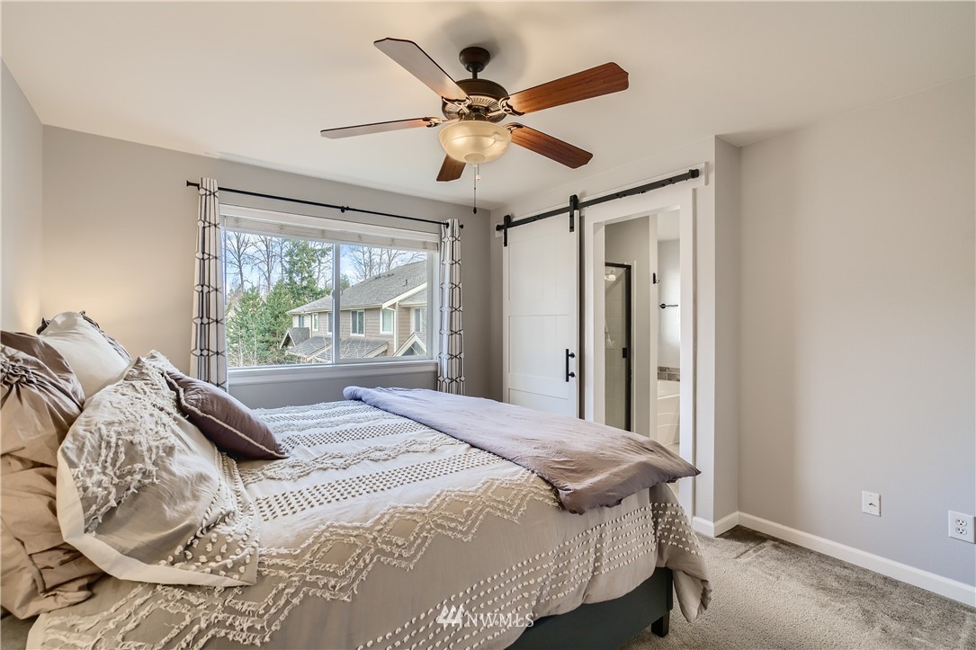320 Chelan Place Northeast, Unit H3 Renton, WA 98059 - Photo 16 of 28 a bed sitting in a bedroom next to a window