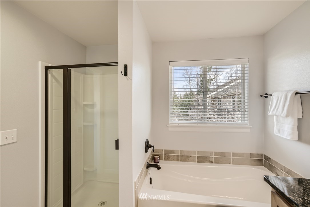 320 Chelan Place Northeast, Unit H3 Renton, WA 98059 - Photo 18 of 28 a bathroom with a bathtub and a shower