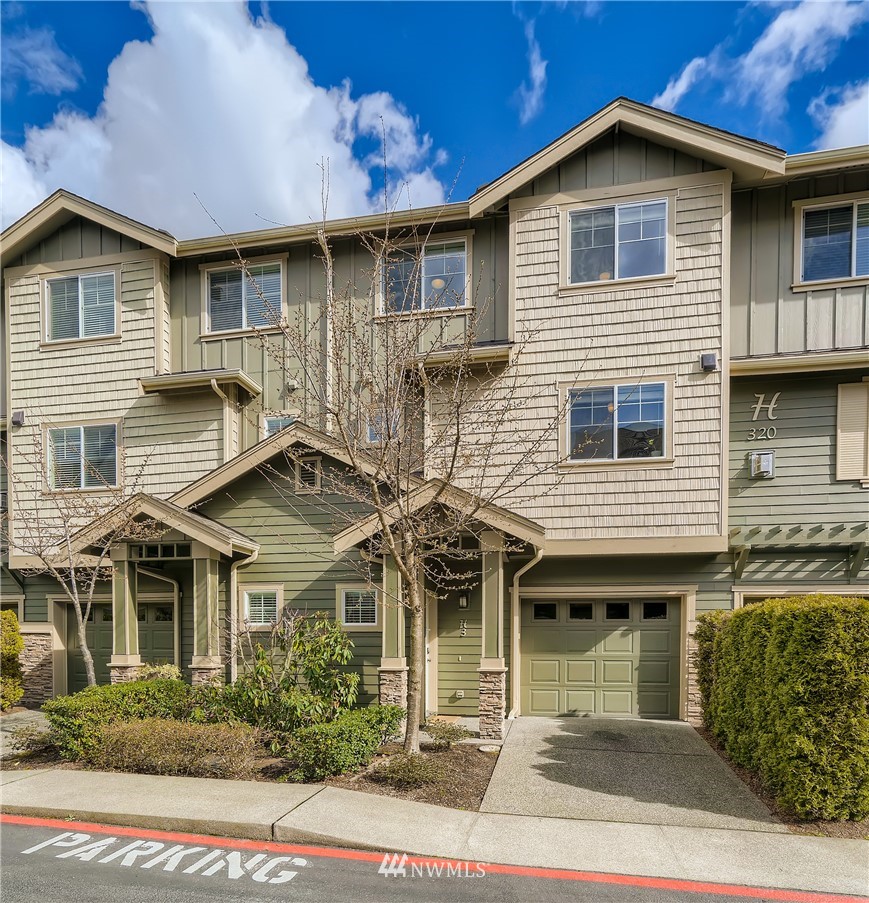 320 Chelan Place Northeast, Unit H3 Renton, WA 98059 - Photo 2 of 28 a front view of a house with garden