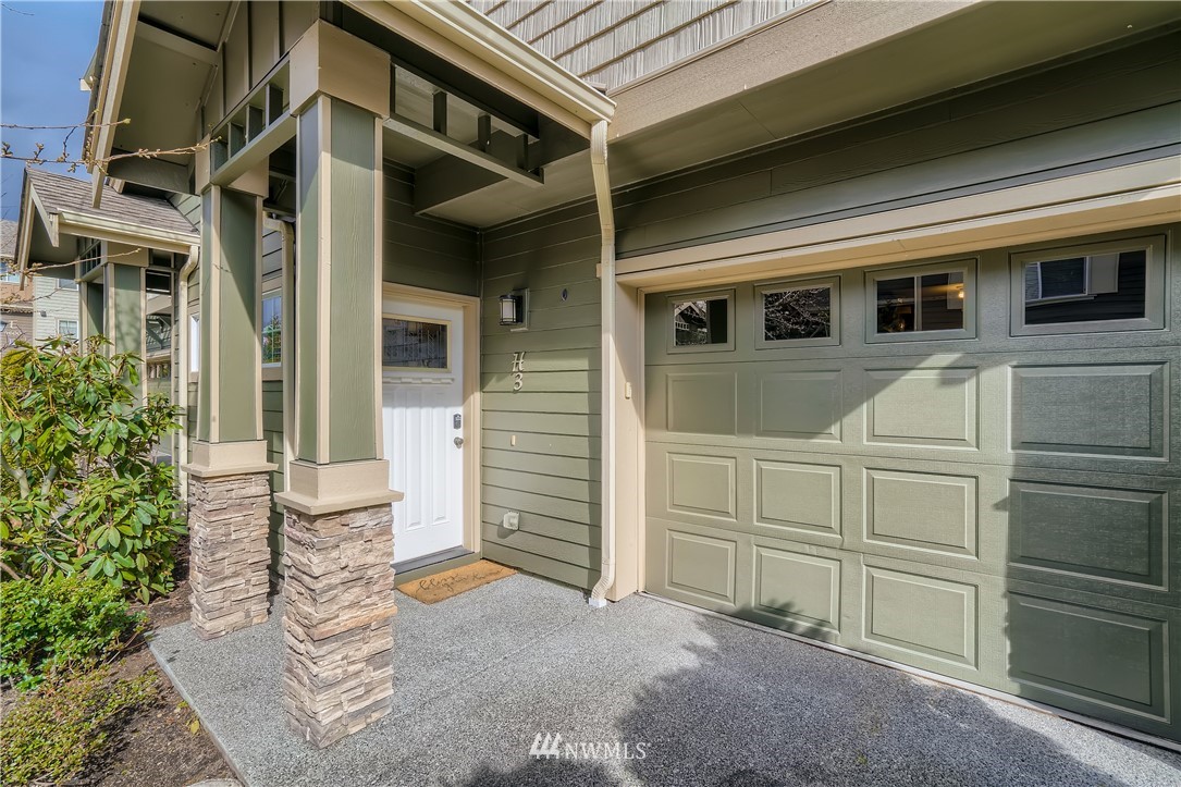 320 Chelan Place Northeast, Unit H3 Renton, WA 98059 - Photo 3 of 28 a view of a car garage door