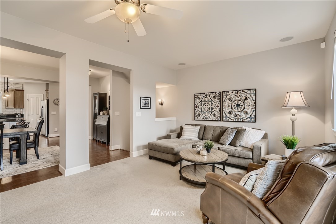 320 Chelan Place Northeast, Unit H3 Renton, WA 98059 - Photo 5 of 28 a living room with furniture and a wooden floor