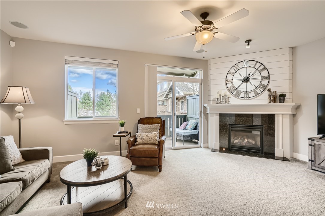 320 Chelan Place Northeast, Unit H3 Renton, WA 98059 - Photo 7 of 28 a living room with furniture a fireplace and a chandelier