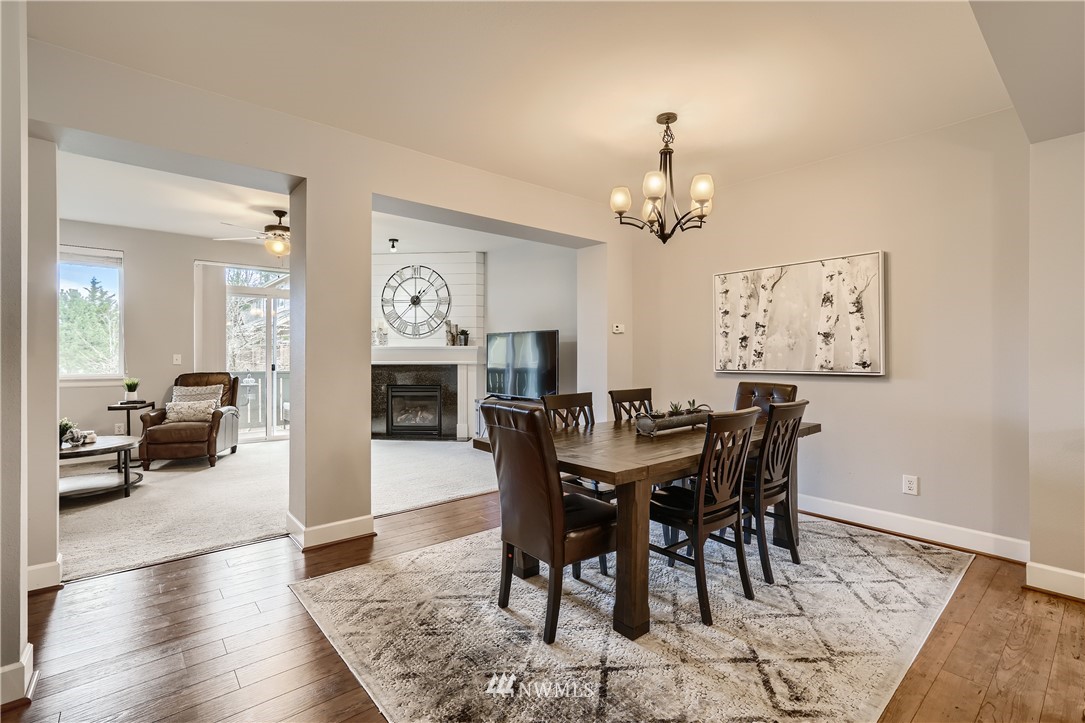 320 Chelan Place Northeast, Unit H3 Renton, WA 98059 - Photo 8 of 28 a view of a a dining room with furniture window and wooden floor