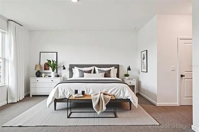 a spacious bedroom with a bed and a couch